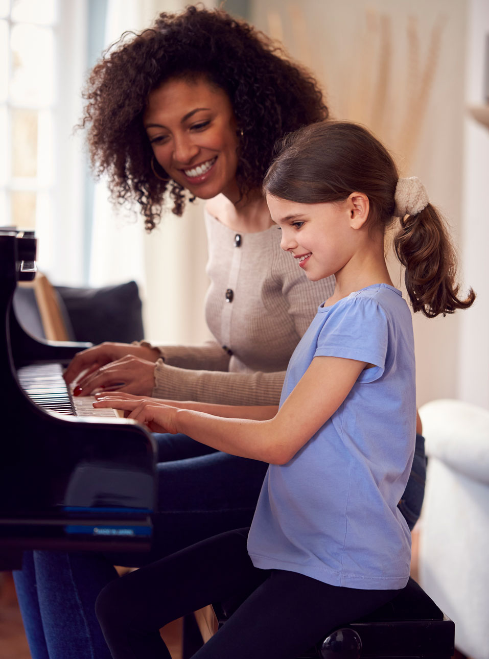 Teacher-and-student-playing-piano-at-home